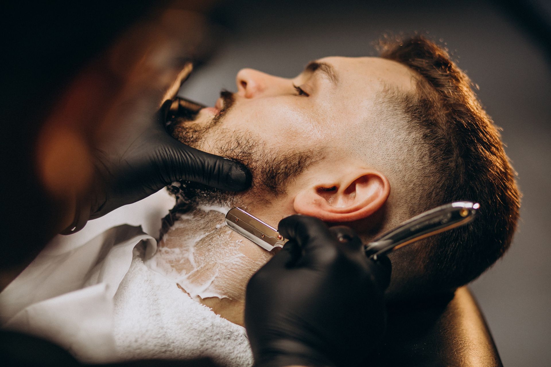 handsome-man-cutting-beard-barber-salon